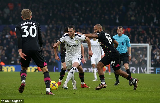 Jack Harrison tries to get away from the Brentford defenders during the Premier League match