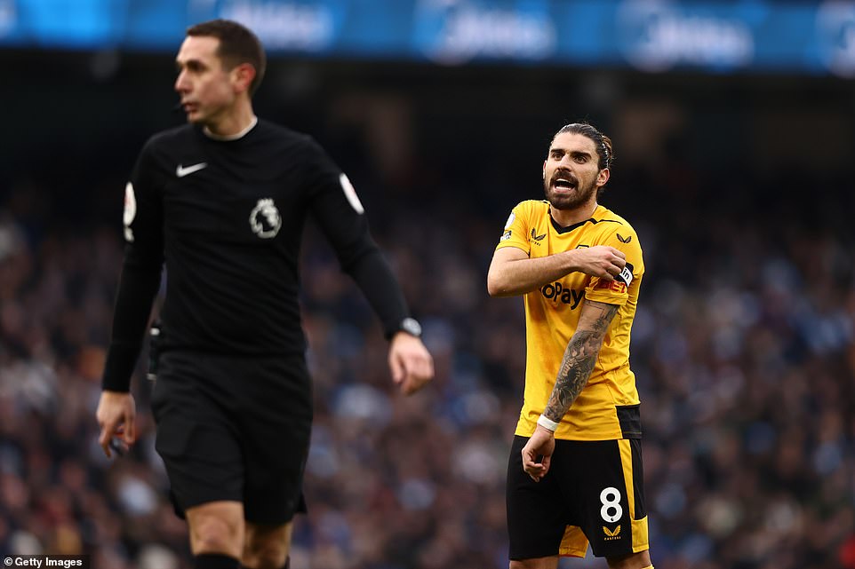 It was a difficult day for Wolves captain Ruben Neves (right) who conceded a penalty after tripping Ilkay Gundogan in the box.