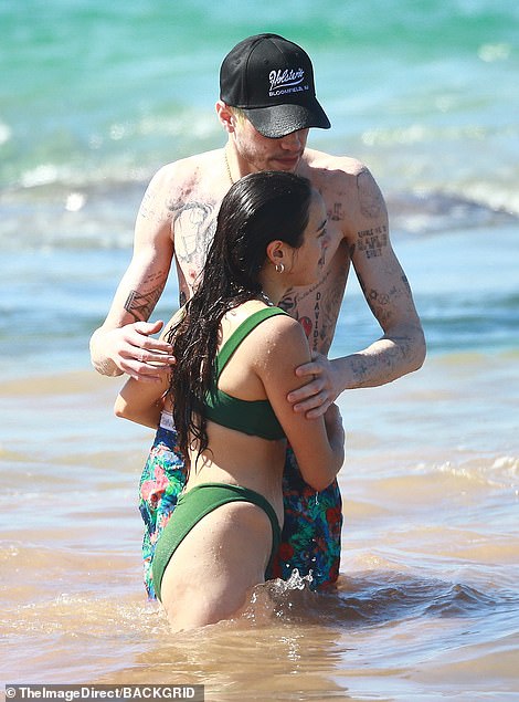 Smitten: As the new couple plunged into the shimmering sea together, the 29-year-old former Saturday Night Live star held the 26-year-old actress in a sweet hug as she gazed up at him adoringly.