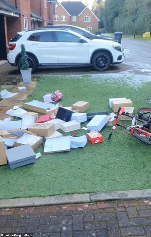 The boxes, which appear to be empty, sit next to a boy's BMX bike sitting on the front lawn.