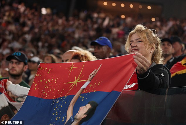 Fan holds a banner in support of Novak Djokovic of Serbia during his third round match against Grigor Dimitrov of Bulgaria