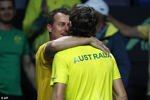 De Minaur and team captain Lleyton Hewitt share a hug after the young Australian star beat Marin Cilic to guide Australia to the Davis Cup final.