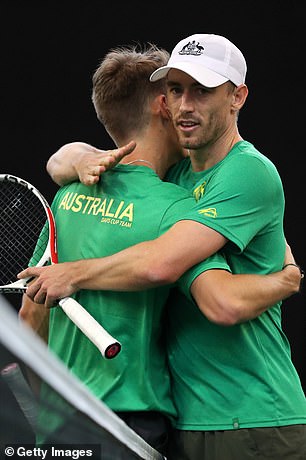 De Minaur and Millman share a hug