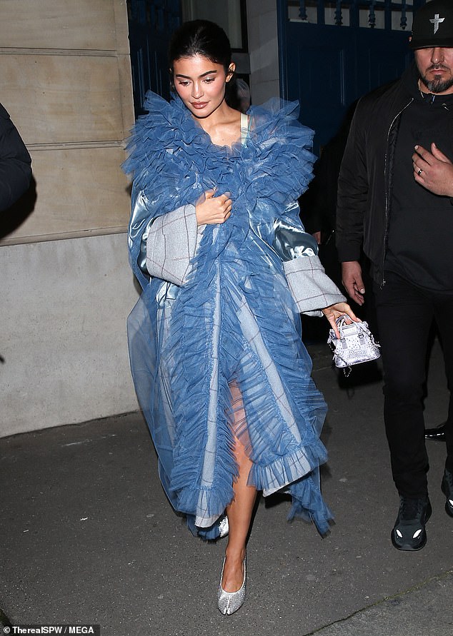 Princess Kylie: She later stepped out in a striking baby blue coat and silver heels to Maison Margiela's Paris Fashion Week show, resembling a Cinderella look.