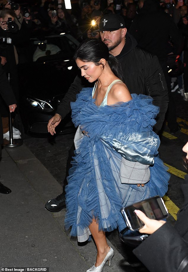 Protection: Jenner was escorted out by security who made sure she was safe as a crowd gathered around her