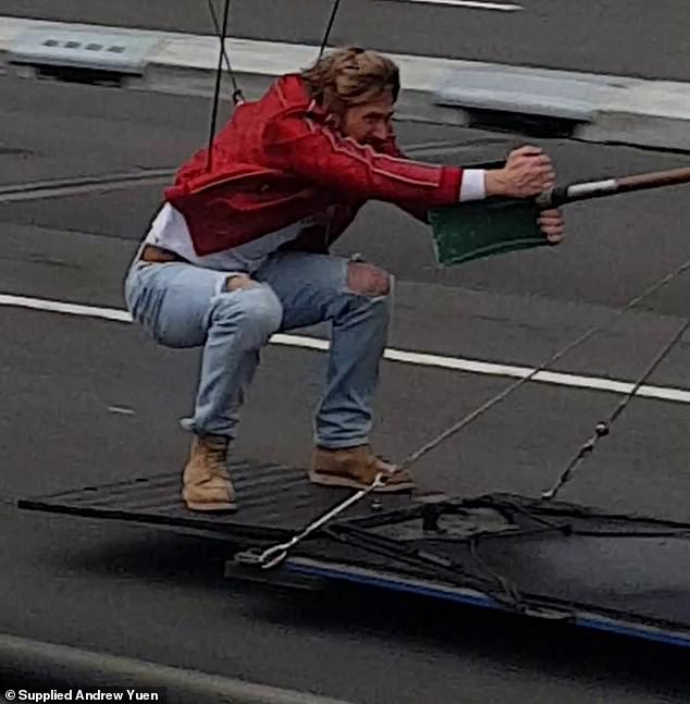 The 42-year-old Canadian actor was filmed hanging on for dear life to the edge of a dumpster being driven by a truck across the famous bridge.