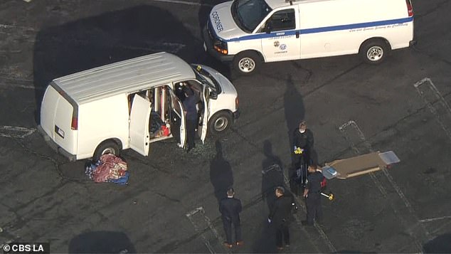 Aerial footage shows officials removing unknown items from the white van after the confrontation.