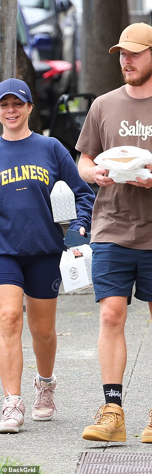 Kate dressed casually in navy shorts and a navy jumper.