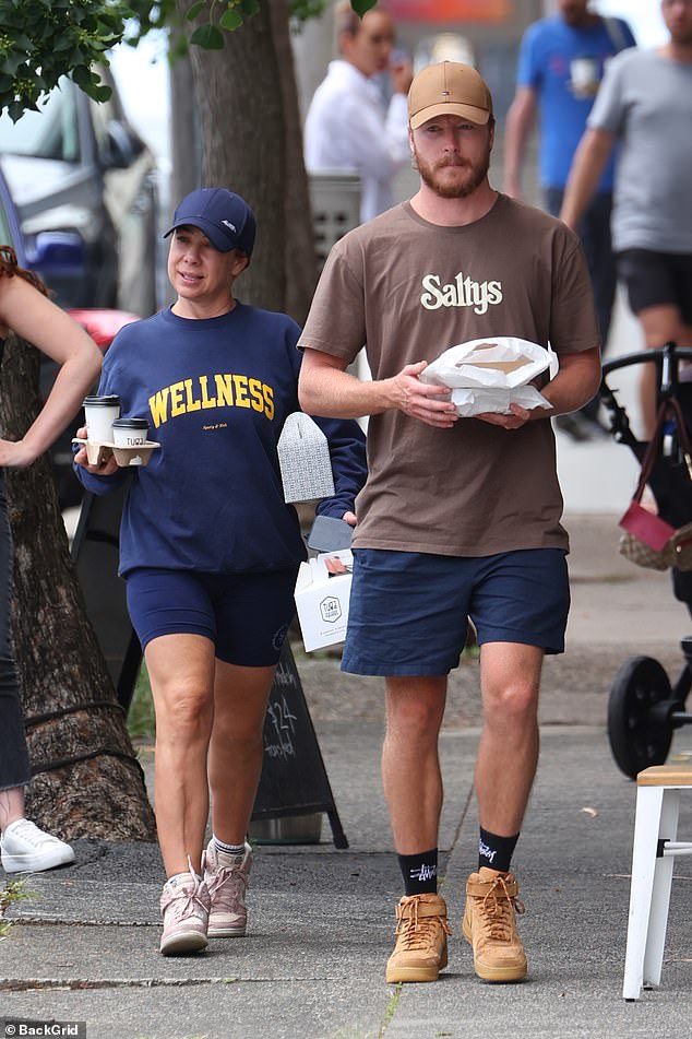 Kate's mysterious male partner was also dressed for comfort in navy shorts, a brown T-shirt, and sneakers.