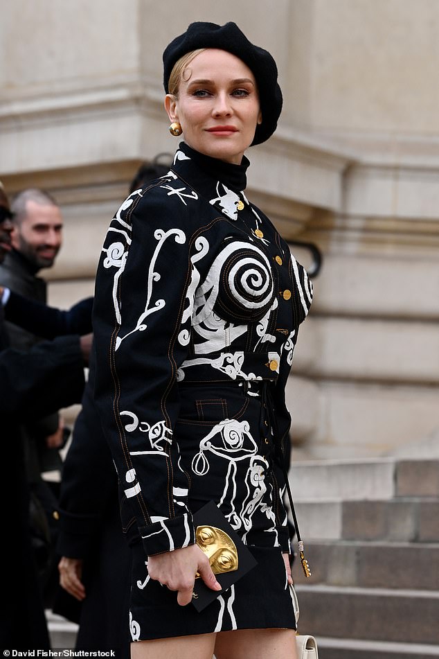 Stunning: The actress, 46, looked sensational in a quirky black and white mini dress and posed up a storm before taking a front row seat