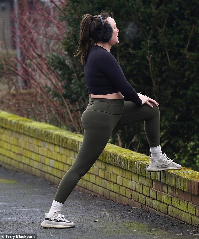 Cool Down: Charlotte was later seen stretching her muscles while putting a leg up on the wall.