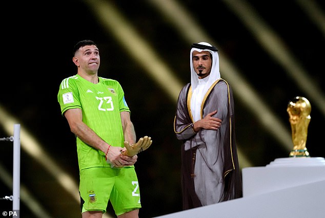 Martínez (left) crudely celebrated with his Gold Glove award after the World Cup final in Qatar