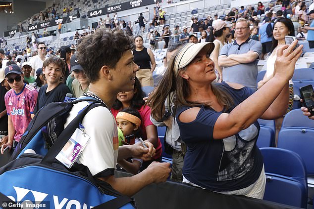 Fans are clamoring for selfies with the 20-year-old as he walks off the court after his big win.