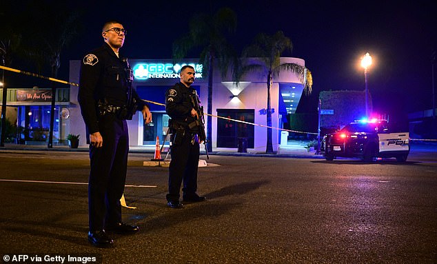 Officers stand guard at the scene near the intersection of Garvey and Garfield Avenue.