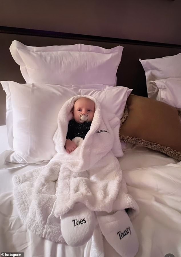 Nice!  In the pictures, the couple is seen doting on her son and in another picture their little baby can be seen wearing a hotel robe with adorable 'toesty toes' slippers.