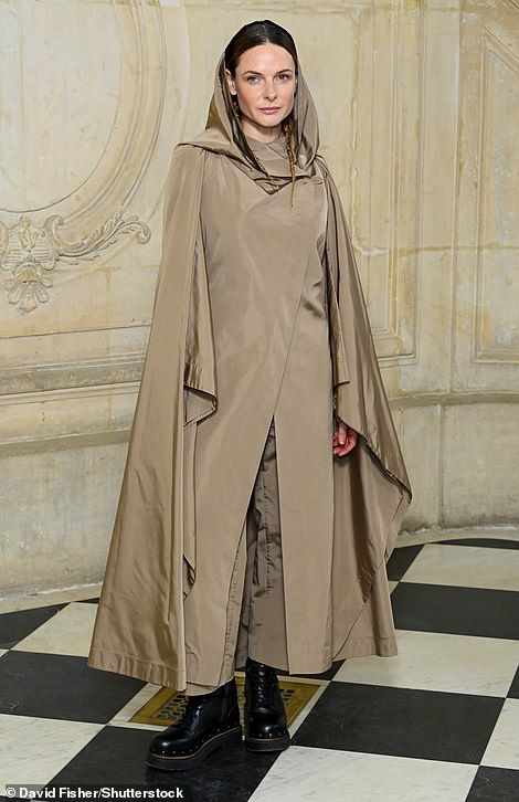 Extravagant: Rebecca Ferguson wore a long beige hooded coat which she paired with chunky black boots