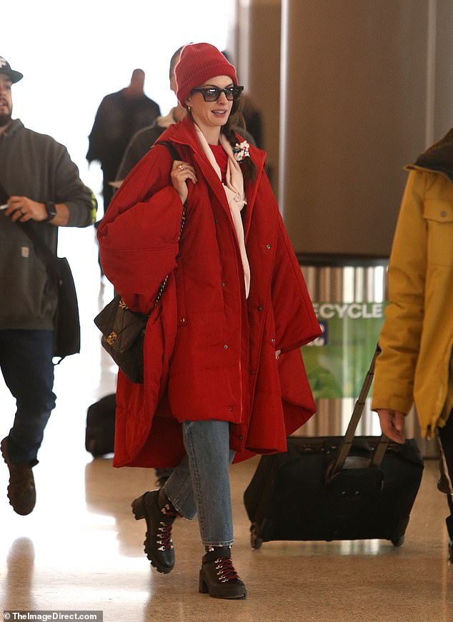 Casual: For her flight, the mother-of-two looked comfortable as she wore her dark brown hair in a ponytail, a pair of light blue jeans, and black leather combat boots