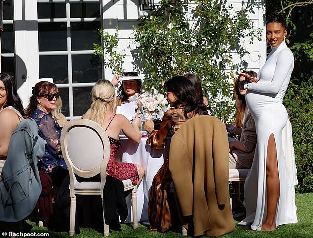 Woman of the moment: The beauty interacted with her guests as they sat down to eat and be merry.