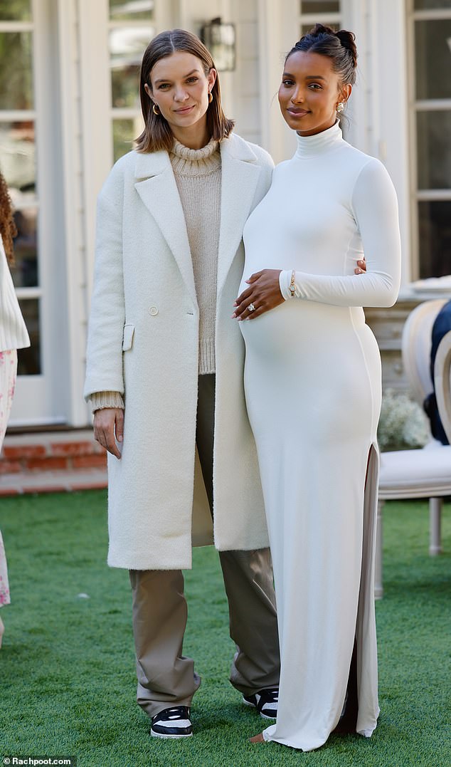 Sweet photo shoot: Jasmine placed a protective hand on her tummy as she posed with Josephine