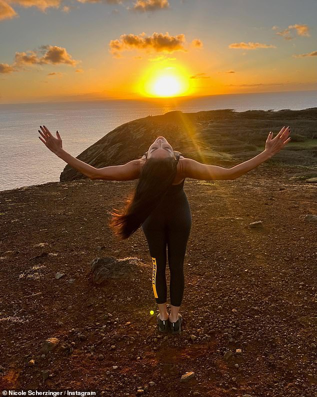 Soaking it all in: The singer went fresh with her long, dark hair falling down her back in beachy waves