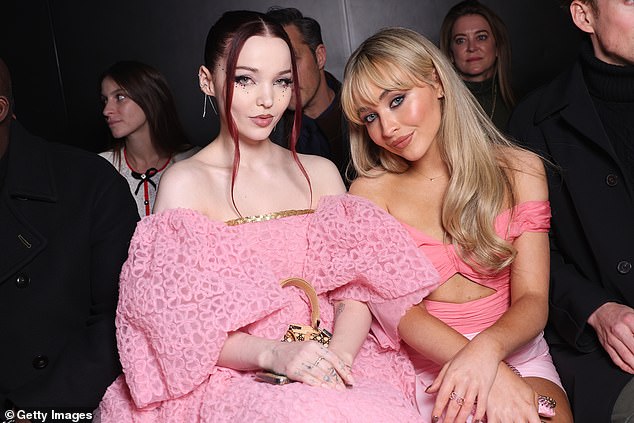 Pals: Dove was joined in the front row by Sabrina Carpenter, who also opted for an all-pink ensemble.