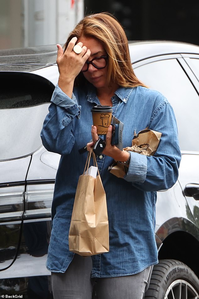 The former Home and Away star was carrying a coffee and a muffin along with hair care products as she walked back to her car after her haircut.