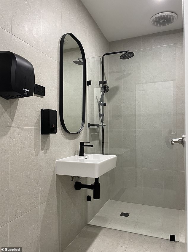 Doing away with walk-in showers, Plus Fitness now has ensuite bathrooms with sleek matte black hardware