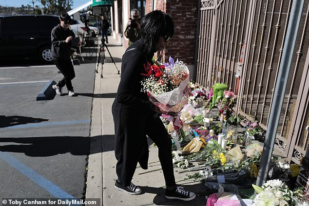 People left floral tributes at the site of one of the shootings Monday throughout the day.