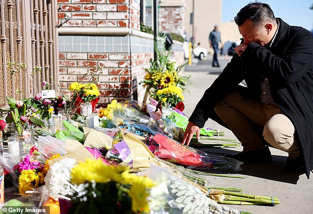 Monterey Park Mayor Henry Lo kneels at a makeshift memorial outside the scene of a deadly mass shooting at a ballroom dance studio Monday in Monterey Park, California.