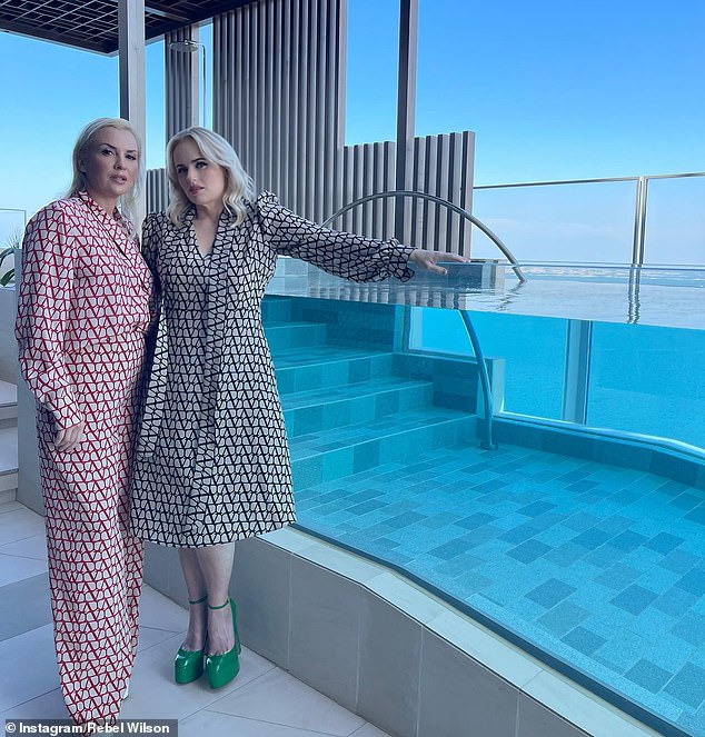 Wilson, 42, uploaded a gallery of snaps to Instagram on Tuesday showing her and Agruma posing side by side in matching outfits on a balcony next to a luxurious swimming pool.