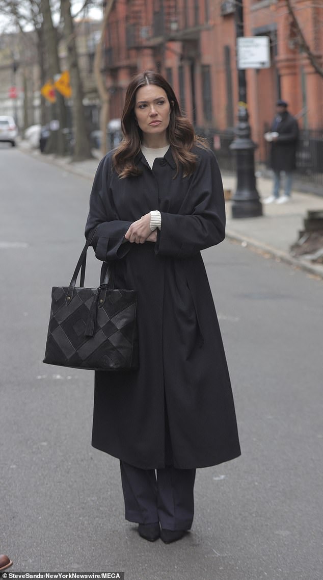 Oversized coat: The This Is Us star, 38, donned an oversized black coat and a matching pair of pants  She was also carrying a large black bag.