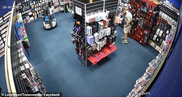 The customer looks around the store before shoving the item into his pocket while pretending to keep looking around.