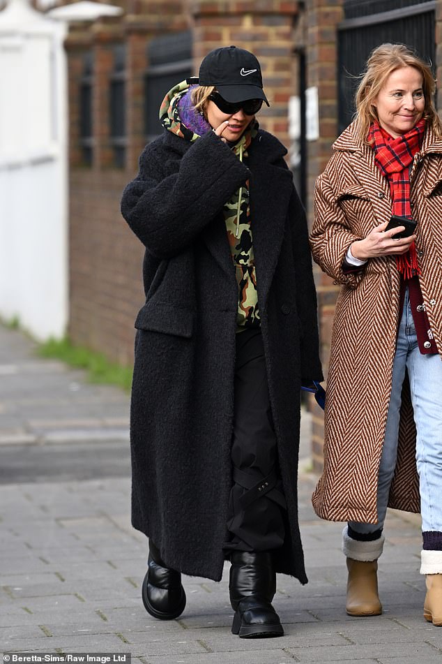 Low key: Keeping a low profile, she made sure to don a pair of sunglasses and a black Nike baseball cap over her golden blonde locks.