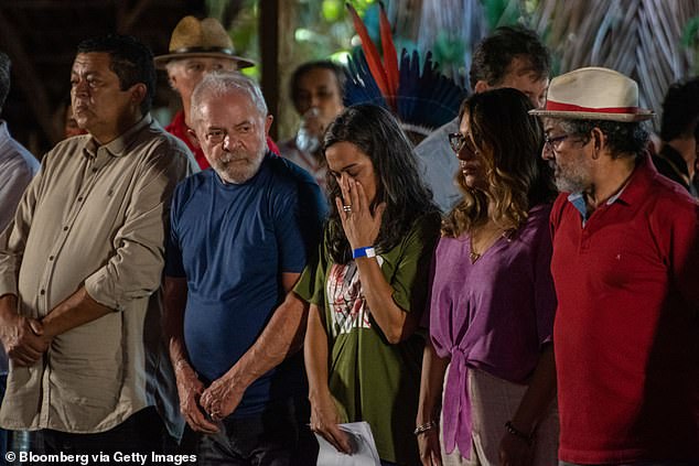 Beatriz Matos, widow of human rights activist Bruno Pereira, center, and Luiz Inacio Lula da Silva, former president of Brazil, second from left, attend an event with the indigenous community.