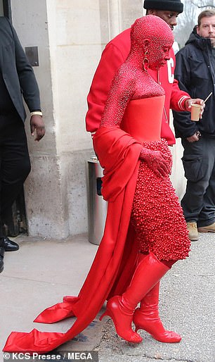 Styling: Her Schiaparelli creation featured a red satin corset paired with a lavishly beaded skirt and knee-high boots;  30k Swarovski crystals were applied to her and she wore her makeup for five hours.