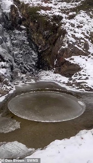 The circular sheet of ice is seen in a glen on the mountain of Beinn Bhuidhe, which is south of Lochan Shira, and north of Achadunan