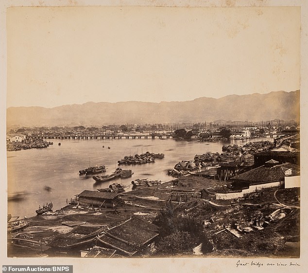 The couple also visited China on their trip around the world.  Above: A bridge spans a river in China, while small wooden boats are seen lining the water.