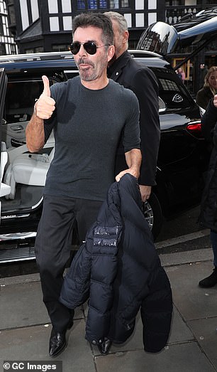 Happy: Simon, who recently shocked fans with his radically different features, was in high spirits.