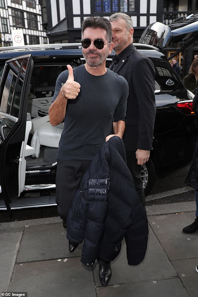 Laid back: Wearing one of his trademark casual outfits, Simon was in high spirits as he stepped out of his car outside the theater to head to the first auditions