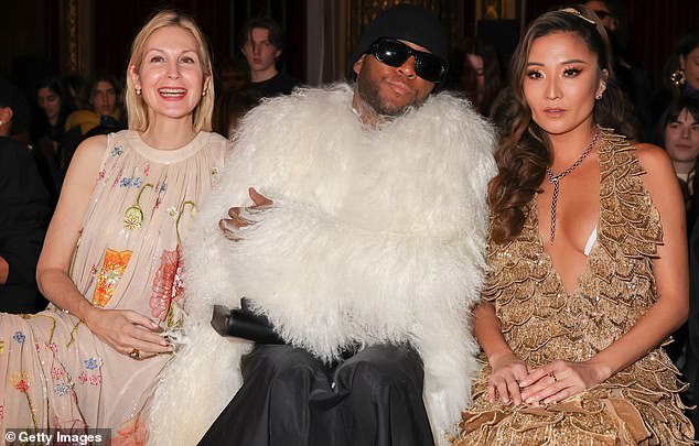 Place to be: After arriving at the show, she settled into a prime seat next to Zendaya's stylist Law Roach and Emily In Paris actress Ashley Park.