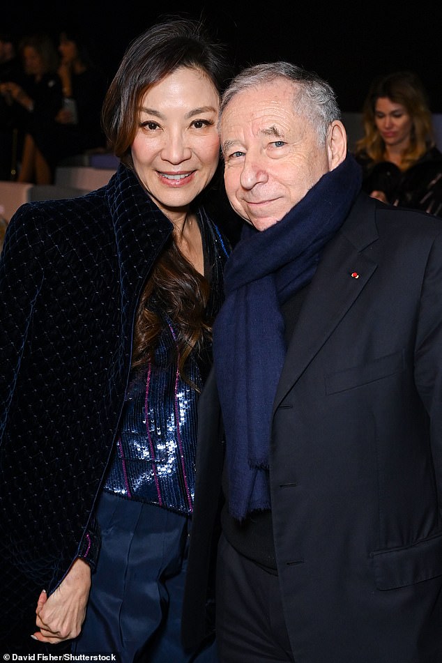 Sharp: Michelle also posed at the fashion show with Jean Todt, who looked sharp in a black blazer and pants.