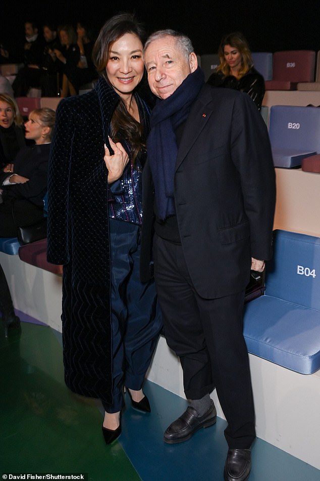 Strike a pose!  He added a navy blue tie to keep him warm as he stood near Michelle for a picture together.