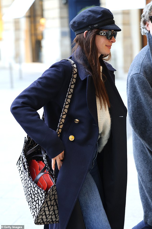 Effortlessly cool: Anne shielded herself from the cold in a sophisticated cream jumper and a long navy wool coat layered over the top.