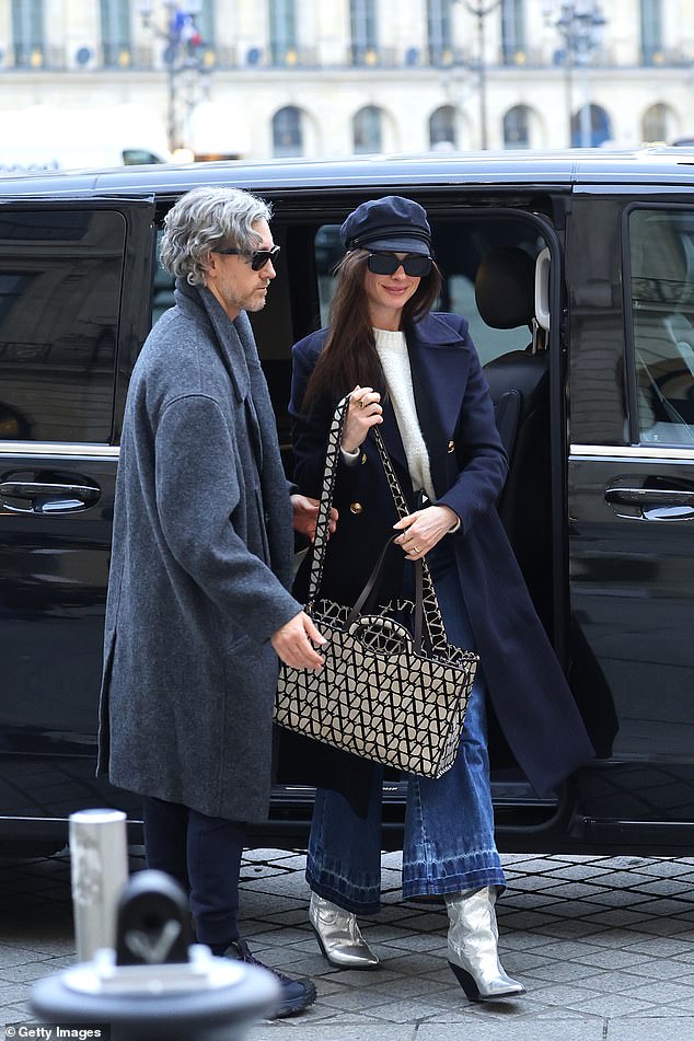 Eye-catching: She increased her height with a quirky pair of metallic silver western-style boots and carried an oversized Valentino Garavani shoulder bag