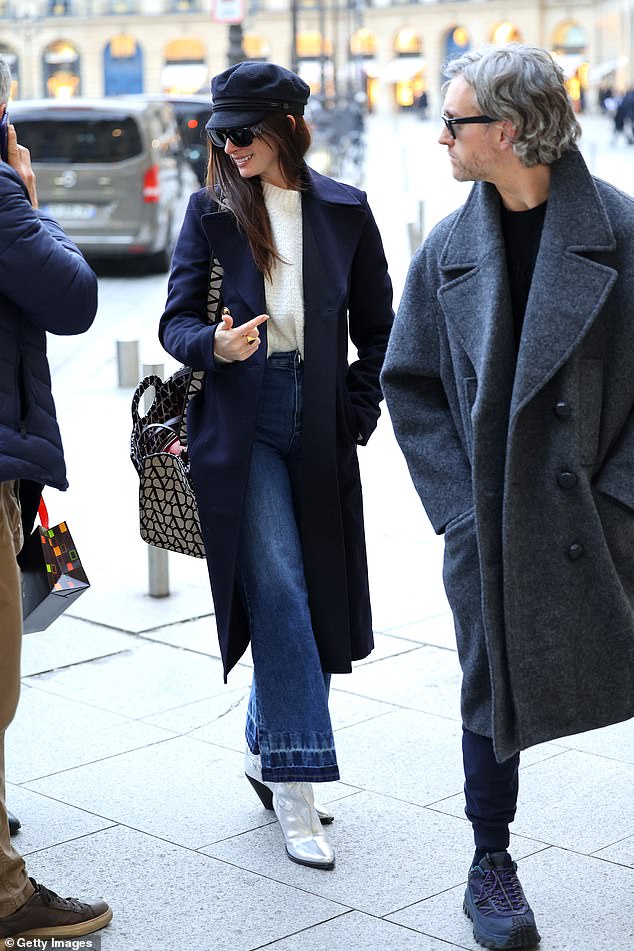 Stunning: Her long brown locks fell into a slicked-back style and she shaded her eyes with rectangular Valentino Garavani sunglasses.