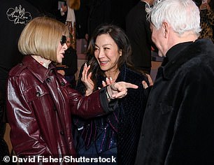 Michelle Yeoh (center) seemed amused by Ms. Wintour's joke