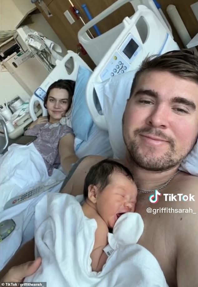 '[A] a healthy puppy was born,' the new mom (pictured with her husband and son) added jokingly.