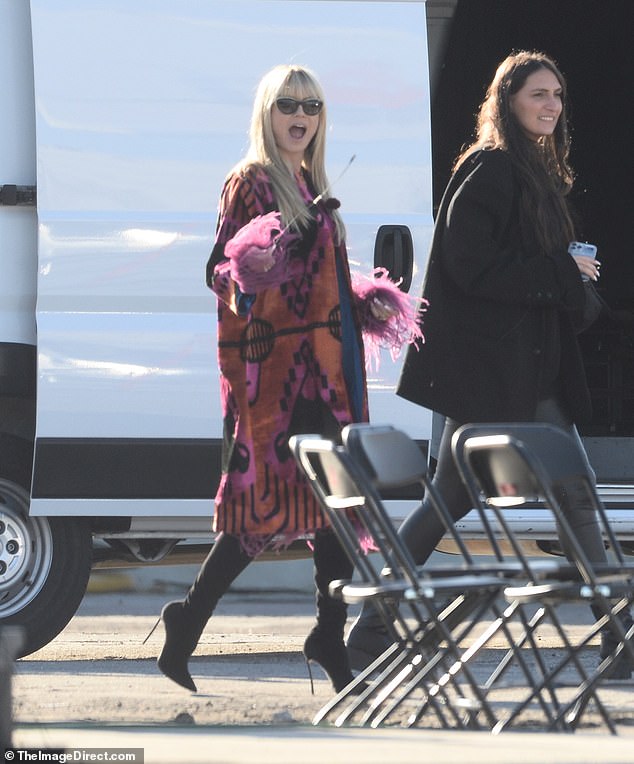 Excited: The German-born star opted to wear a colorful jacket paired with a form-fitting purple dress and heeled black boots for the day of filming