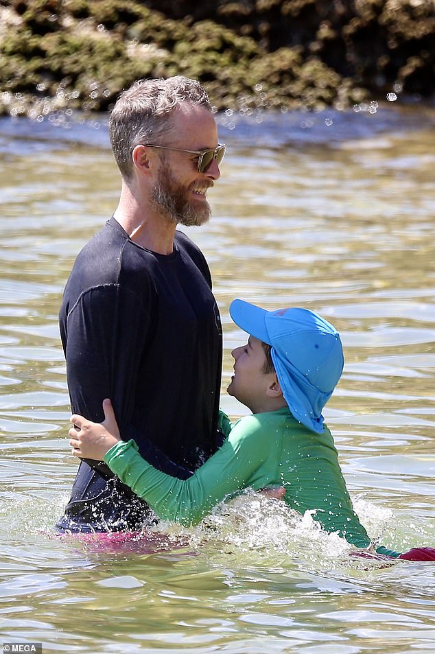 The Gold Logie winning comedian was seen playing with his children as they walked through the ocean.  (Hamish is pictured with his son Sonny's)