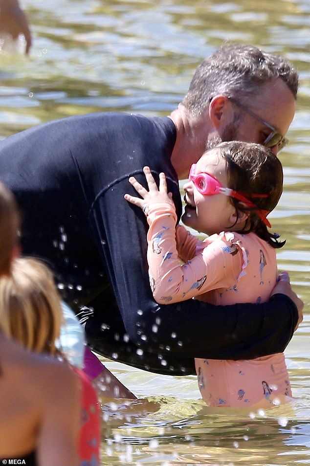 Little Rudy wore a waterproof mermaid print vest and matching pink goggles.